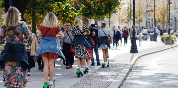 E-Scooterahrer auf Bürgersteig mit Fußgängern